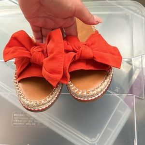 Gently worn orange bow sandals